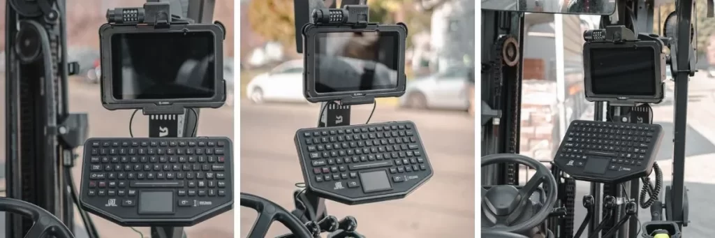 Stacja dokująca z uchwytem montażowym do laptopa, zamocowana w kabinie pojazdu ciężarowego, z możliwością regulacji położenia.
